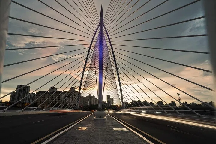 Looking along the deck of the Seri Wawasan bridge at dusk, its asymmetric mast ahead